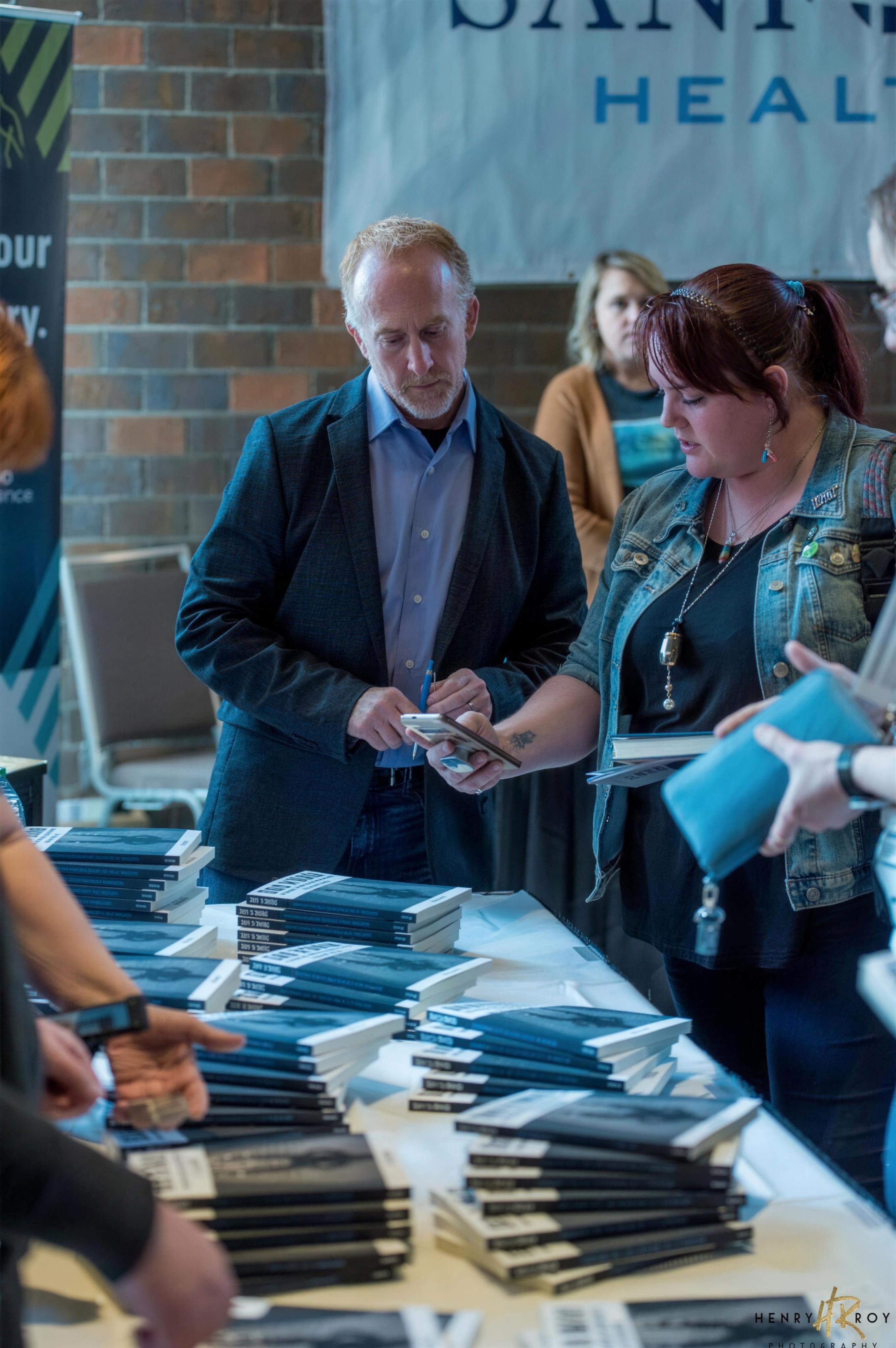 Pete Smith meeting attendees at a book table